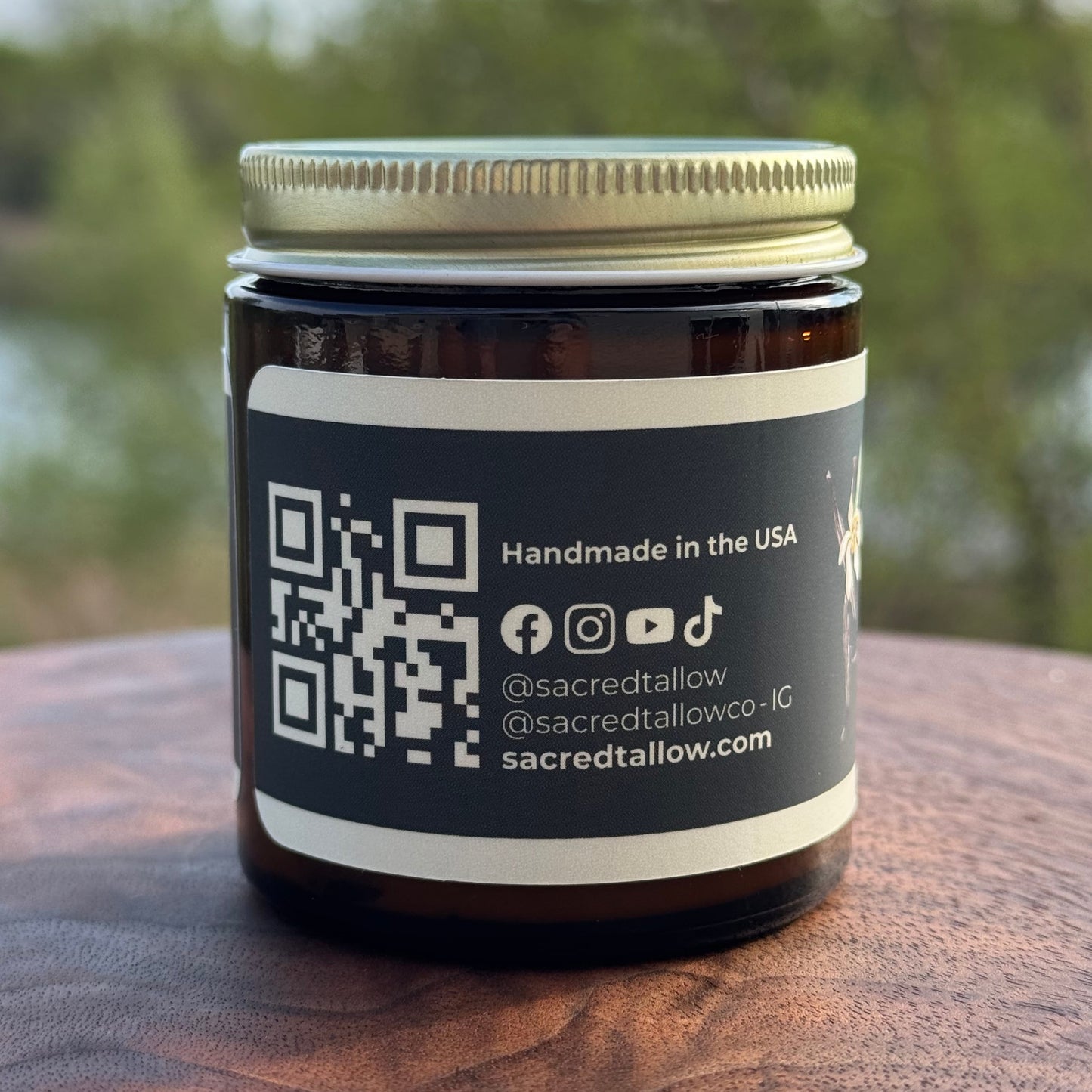 Jar with a label featuring a QR code and social media information on a wooden surface.